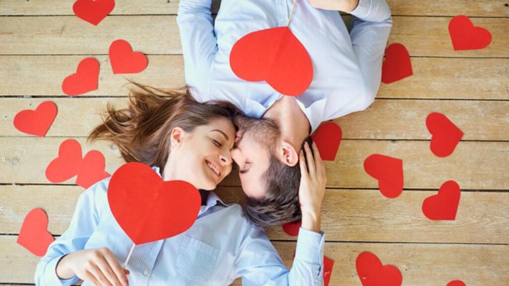 a couple surrounded by hearts and they are kissing