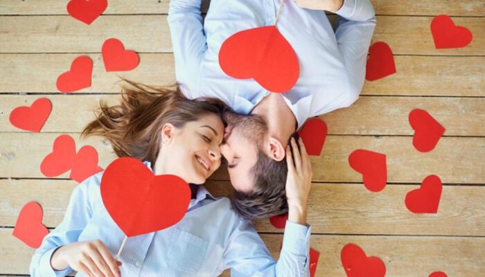 a couple surrounded by hearts and they are kissing