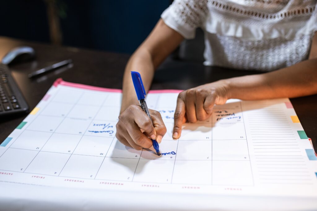 person writing all medellin events on his calendar