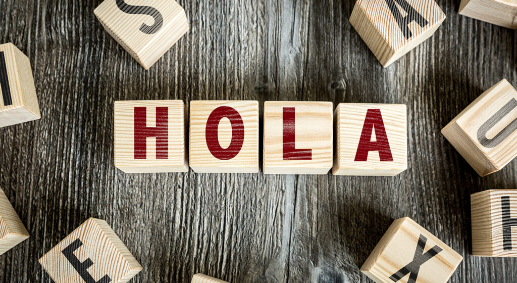 dice forming the word hello (in Spanish)