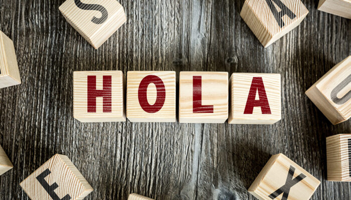 dice forming the word hello (in Spanish)