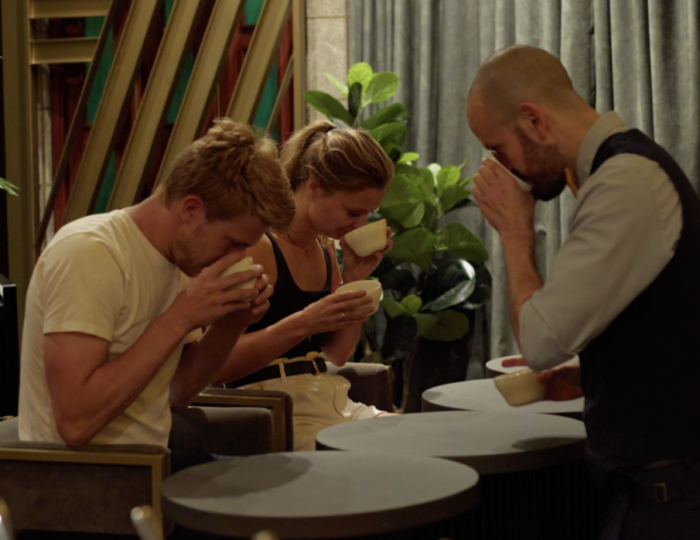 two tourists participating in the coffee tasting at the marquee