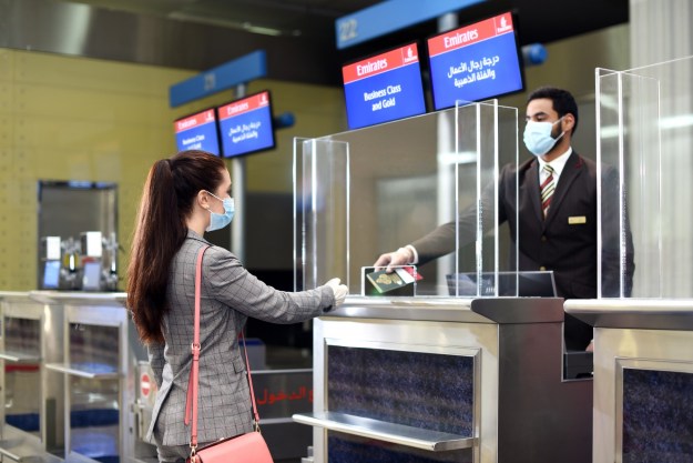 migration man handing passport to girl