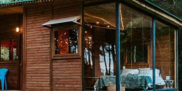cabin made of wood with glass walls
