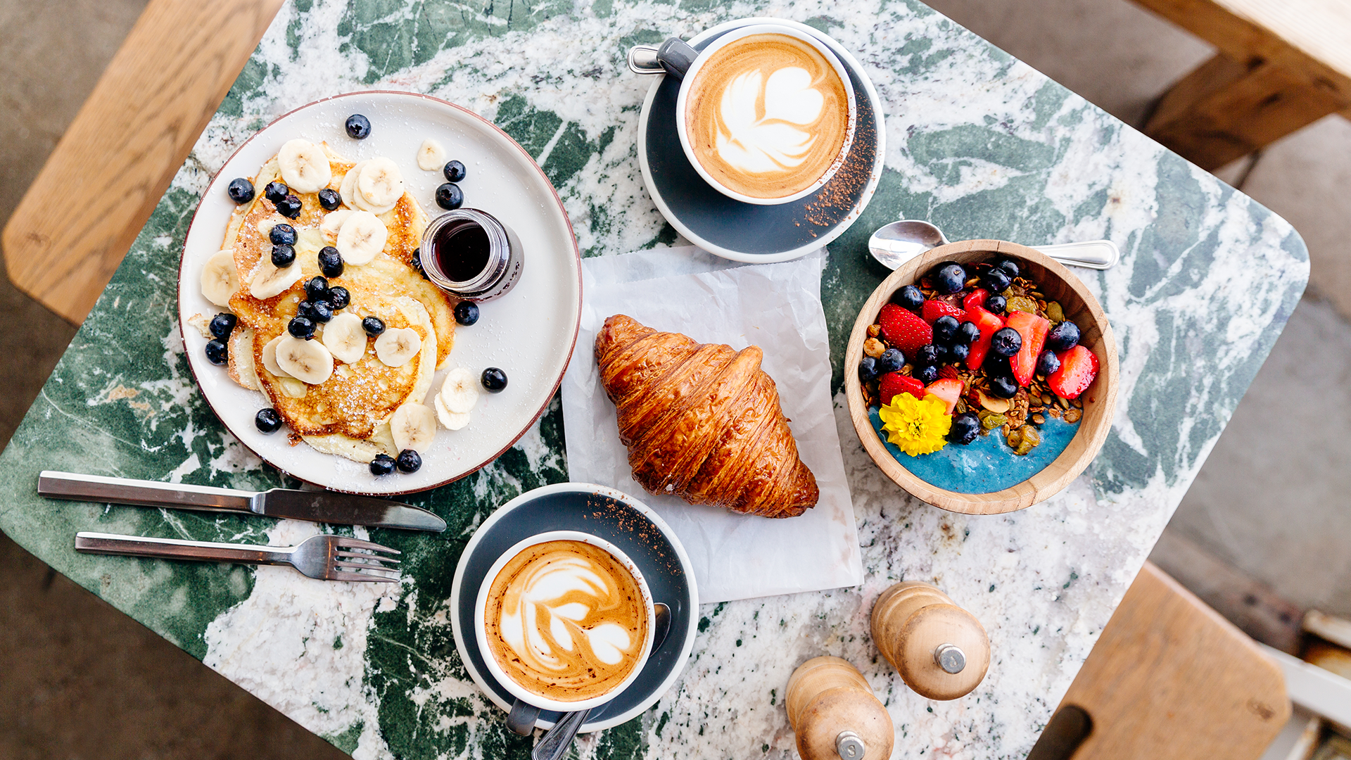 a delicious brunch with cereals, bread, yogurt, coffee and pancakes