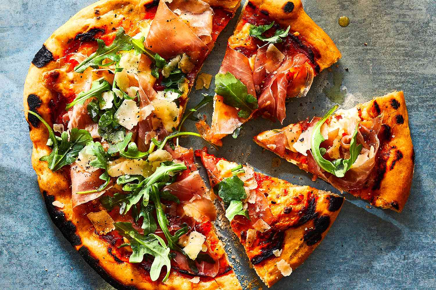 delicious pizza broken into several pieces